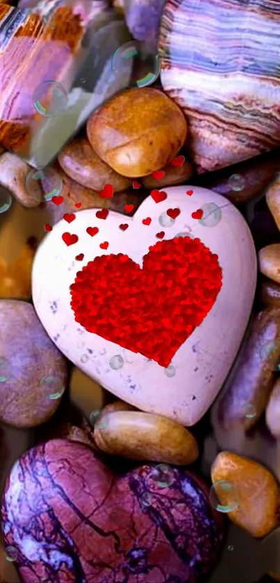 Heart-shaped stone on pebbles with red accents wallpaper.