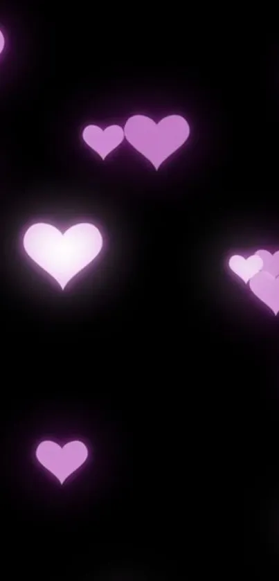 Mobile wallpaper with glowing pink hearts on a dark background.