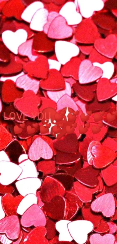 Pile of red and pink heart shapes creating a romantic pattern.