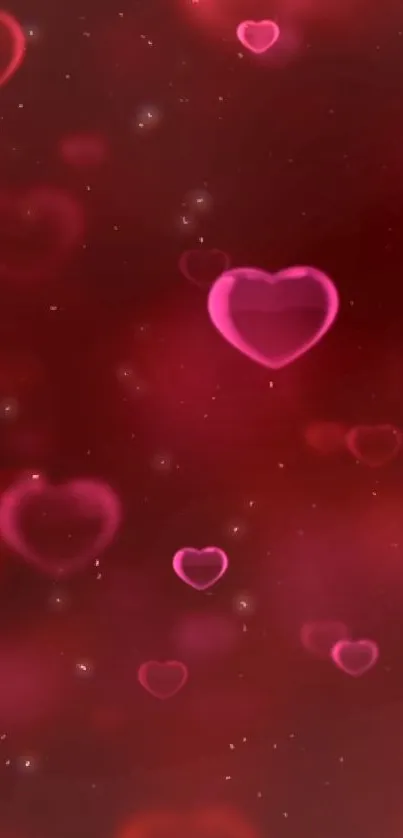 Glowing pink hearts on deep red background mobile wallpaper.