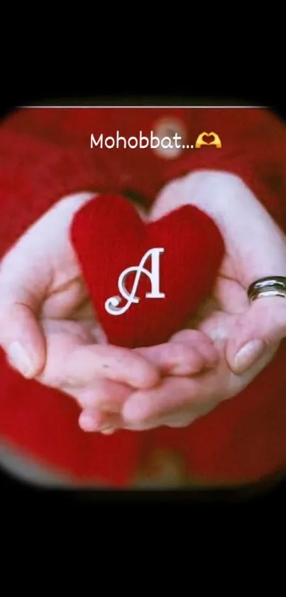 Red heart held in hands against dark background.