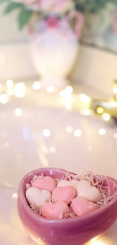 Romantic wallpaper with heart bowl and fairy lights in pastel pink hues.