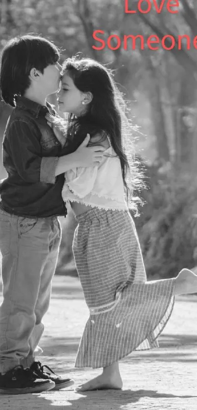 Black and white image of kids sharing a kiss, titled 'Love Someone.'