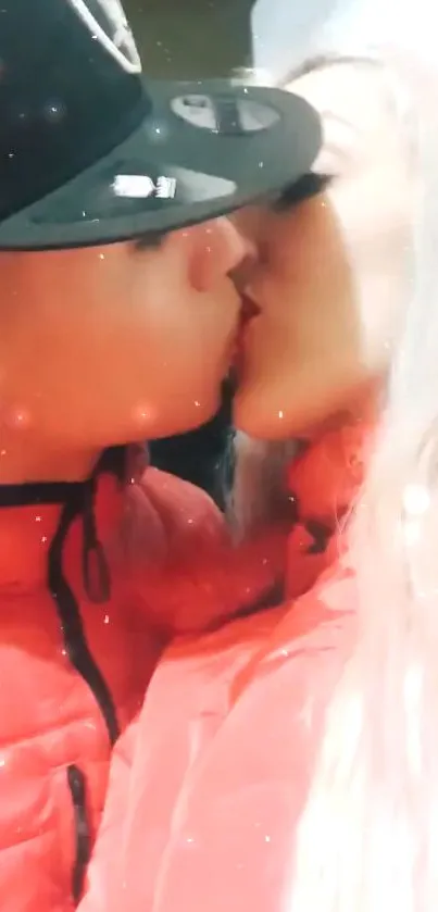 Romantic couple kissing in red jackets.