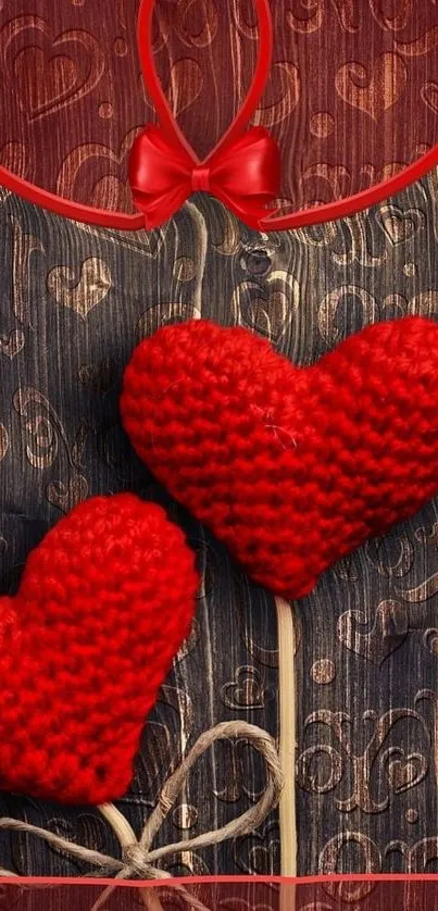 Knitted red hearts on textured brown background.