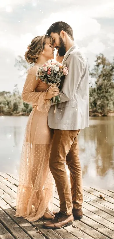 Romantic couple embracing by lake with flowers in hand.