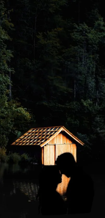 Silhouetted couple by a warmly lit cabin in a serene, dark forest setting.