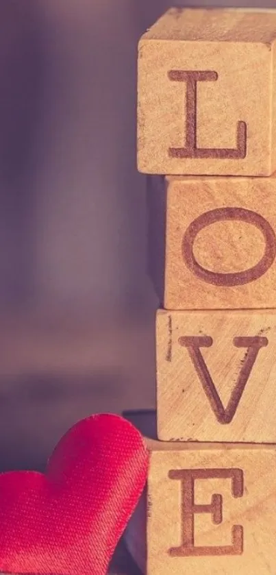 Wooden blocks spelling LOVE with a red heart.