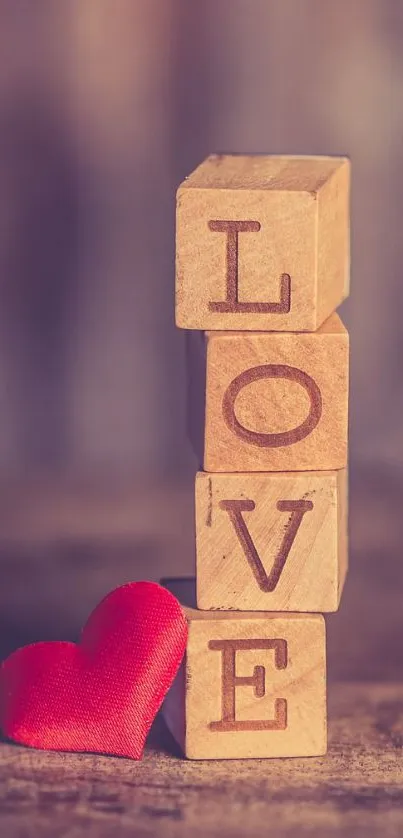 Wooden blocks spelling love with red heart.