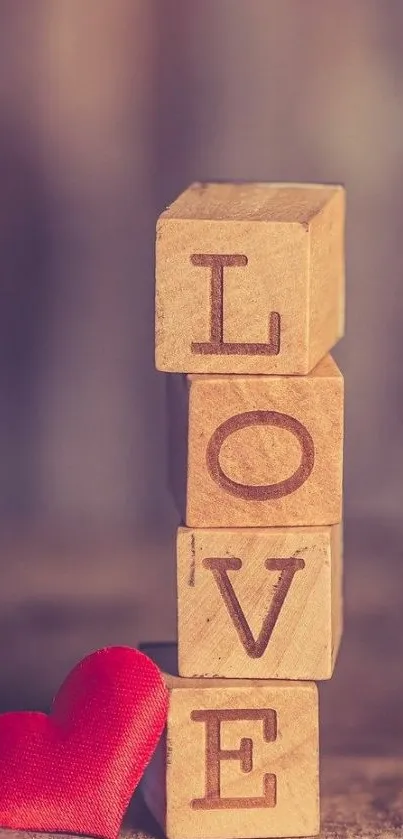 Wooden blocks spell love with a red heart.