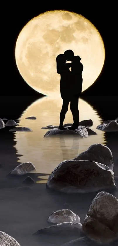 Silhouette of a couple under a full moon with a water reflection and rocks.