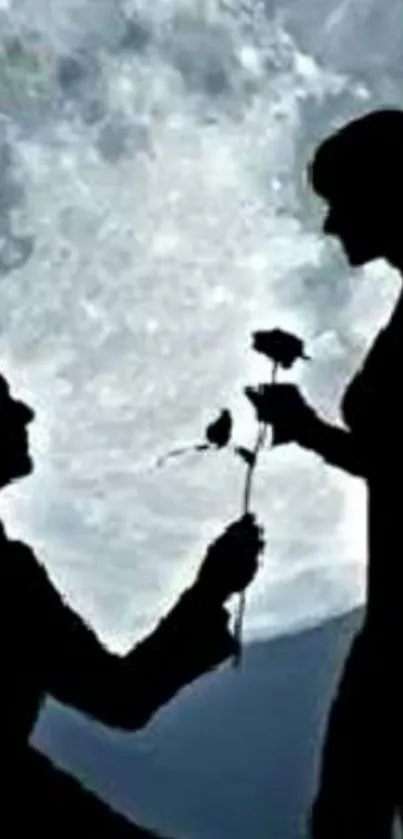 Silhouette of a couple under a full moon in a romantic scene.