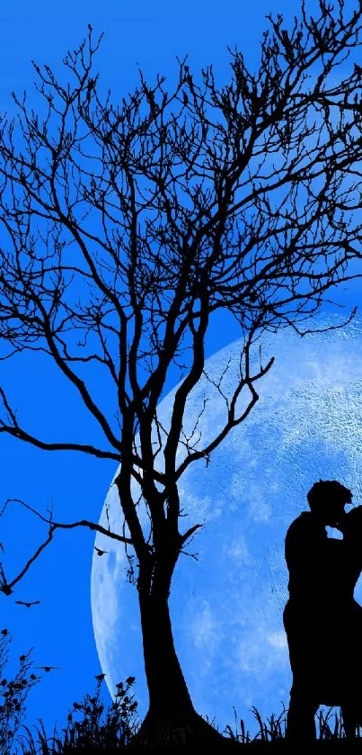 Romantic silhouette of a couple kissing under a blue moonlit sky with a tree in foreground.