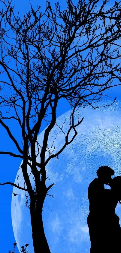 Silhouetted couple hugging by tree under a full blue moon.