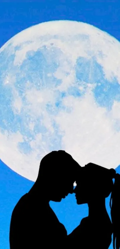 Silhouette couple under large full moon on a sky blue background.