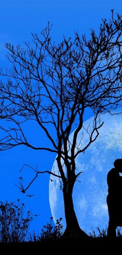 Silhouette of a couple kissing under a tree with a full moon in the background.