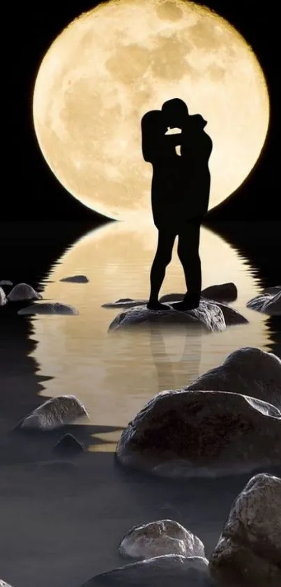 Silhouetted couple embraces under full moon with water reflections and rocks.