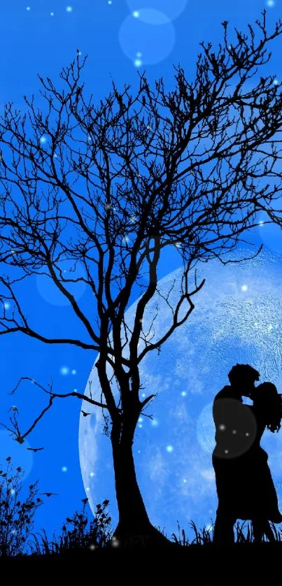 Silhouette of a couple against a blue moonlit sky with a tree in the foreground.