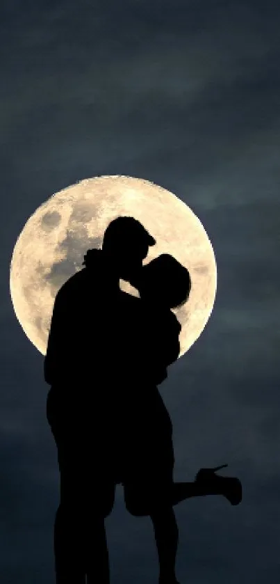 Silhouette of a kissing couple under a luminous full moon.