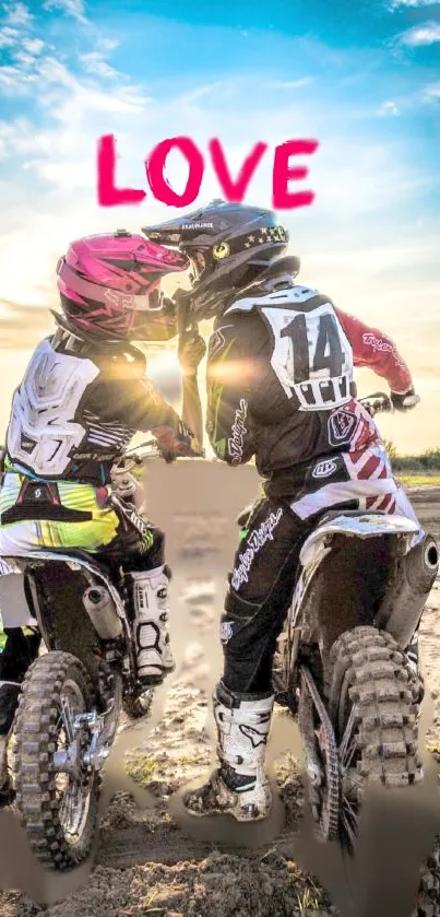 Two motocross riders share a kiss at sunset under the word 'Love' in vibrant colors.