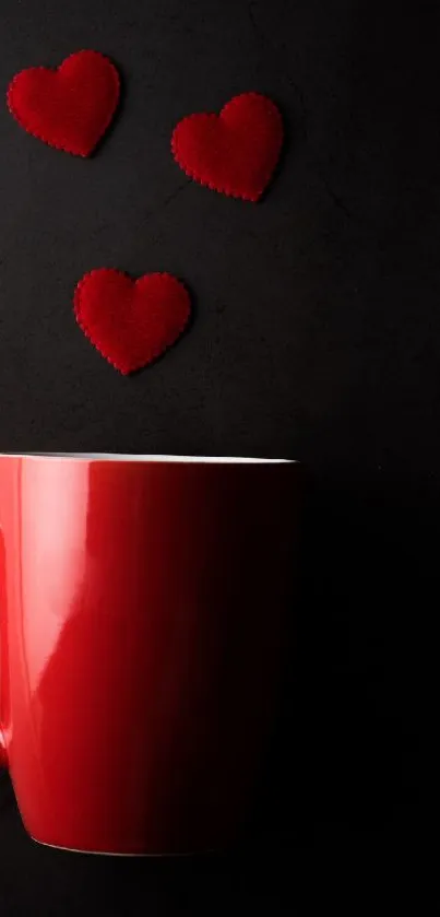 Red mug with heart shapes on dark background.