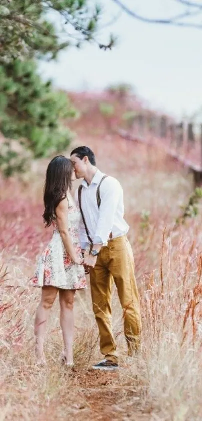 Romantic couple walking in pink grass field.