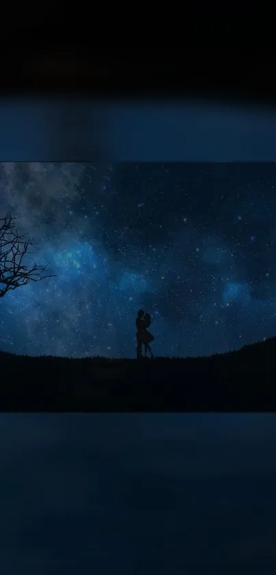 Silhouetted couple embracing under a starry night sky with a barren tree on the side.