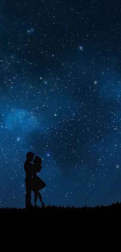 Romantic couple embracing under a starry, dark blue night sky next to a tree silhouette.