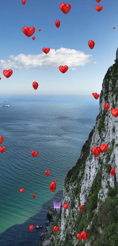 Romantic ocean view with red hearts floating over cliffs and sea.