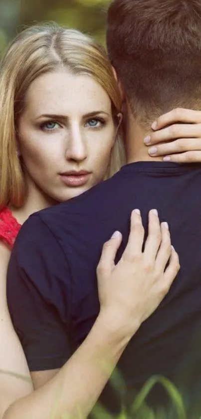 Romantic couple embrace in green nature setting.