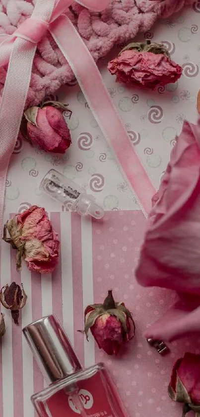 Pink aesthetic mobile wallpaper with roses and a perfume bottle on textured fabric.