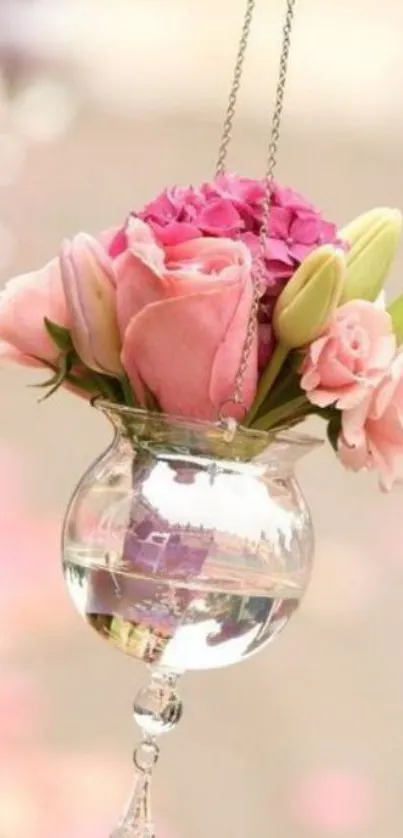 Pink flowers in a hanging glass vase, elegant and romantic.