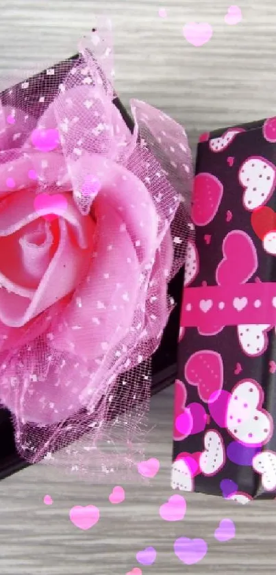 Pink gift box with rose and hearts on a wooden background.