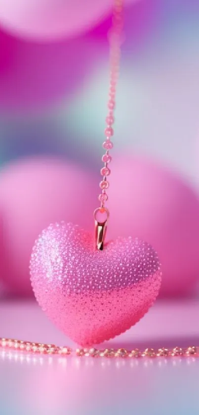 Romantic pink heart charm on chain with blurred colorful background.