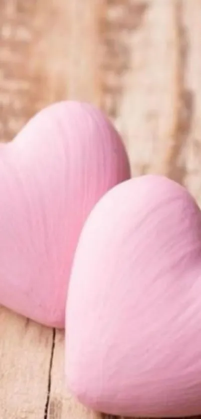 Two pink hearts on wooden background wallpaper.