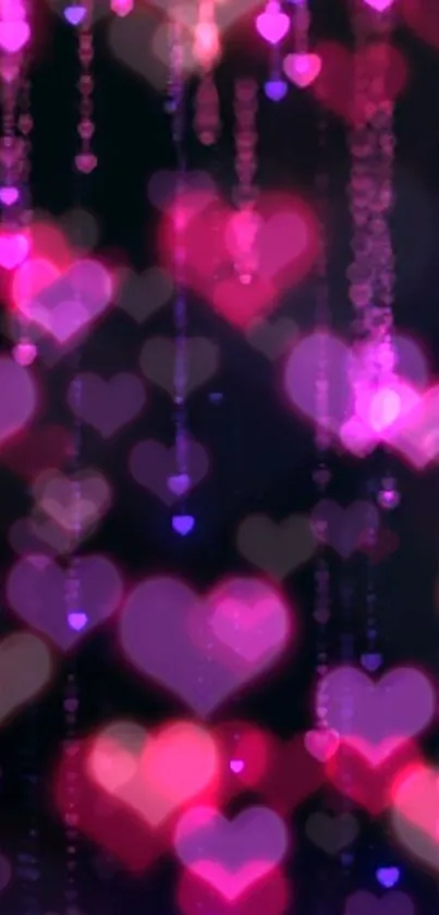 Romantic pink hearts with glowing bokeh effect on a dark background.