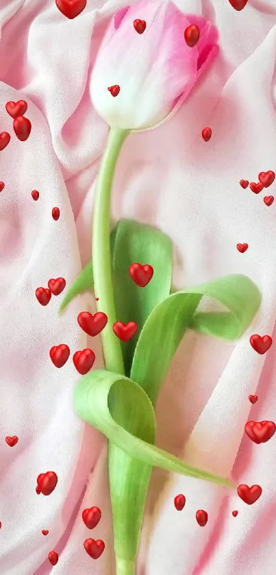 A pink tulip surrounded by red hearts on a soft pink background.