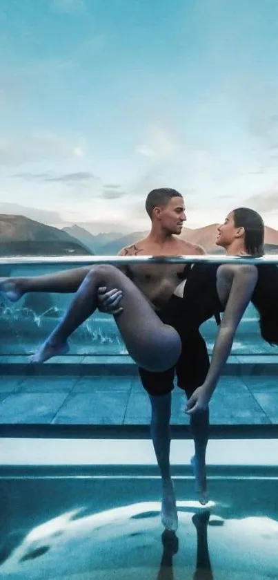 Couple beside pool with mountains and blue sky.