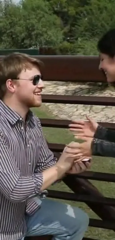 Romantic proposal on a picturesque wooden bridge.