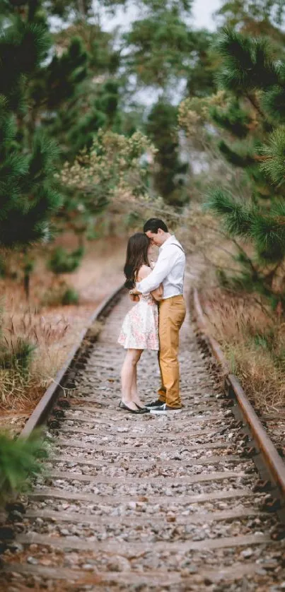 Romantic couple embracing on a forest railway track.