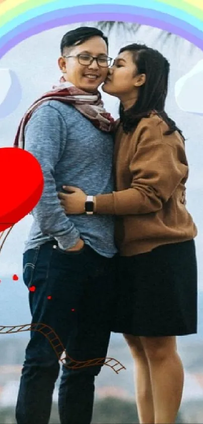 Couple embracing under a rainbow with heart balloon.