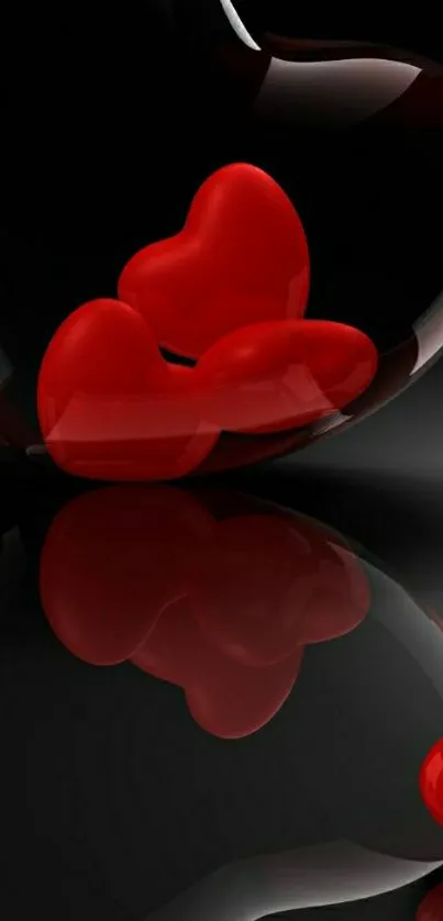 Red hearts reflected on glossy black surface.