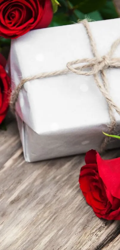 Red roses and gift on wooden background wallpaper.