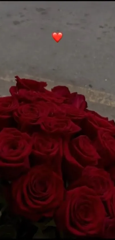 Bouquet of red roses with a heart accent.