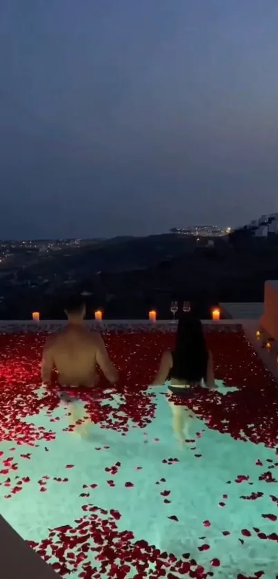 Romantic rooftop pool with rose petals and city lights at night.