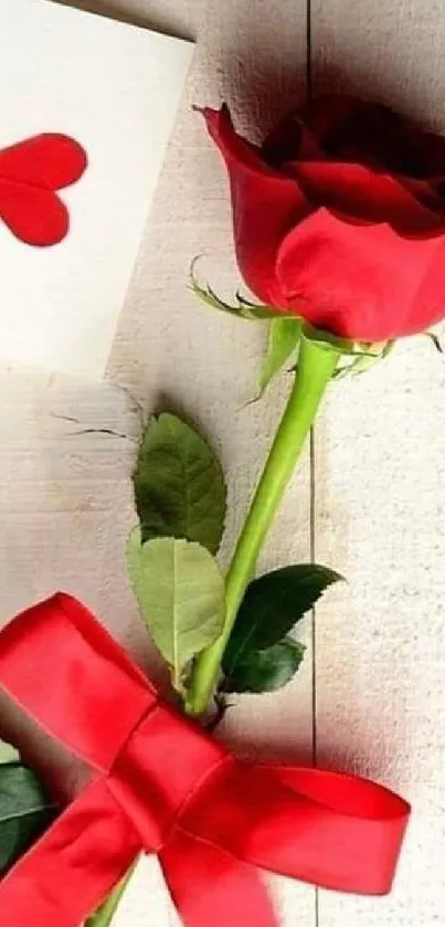 Romantic red rose with a heart card on wooden background.