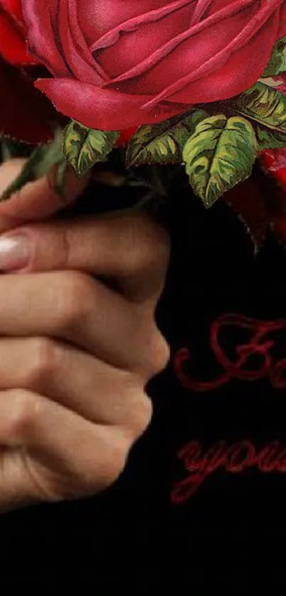 Elegant hand holding a red rose against a black background.