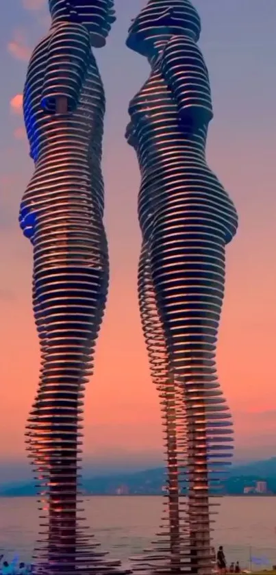 Romantic seaside sculpture with vibrant sunset backdrop.