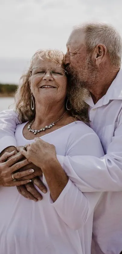 Elderly couple embracing by a serene lakeside, showcasing love.