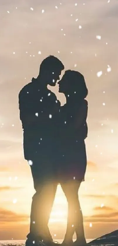 Silhouette of couple at sunset with snowflakes.